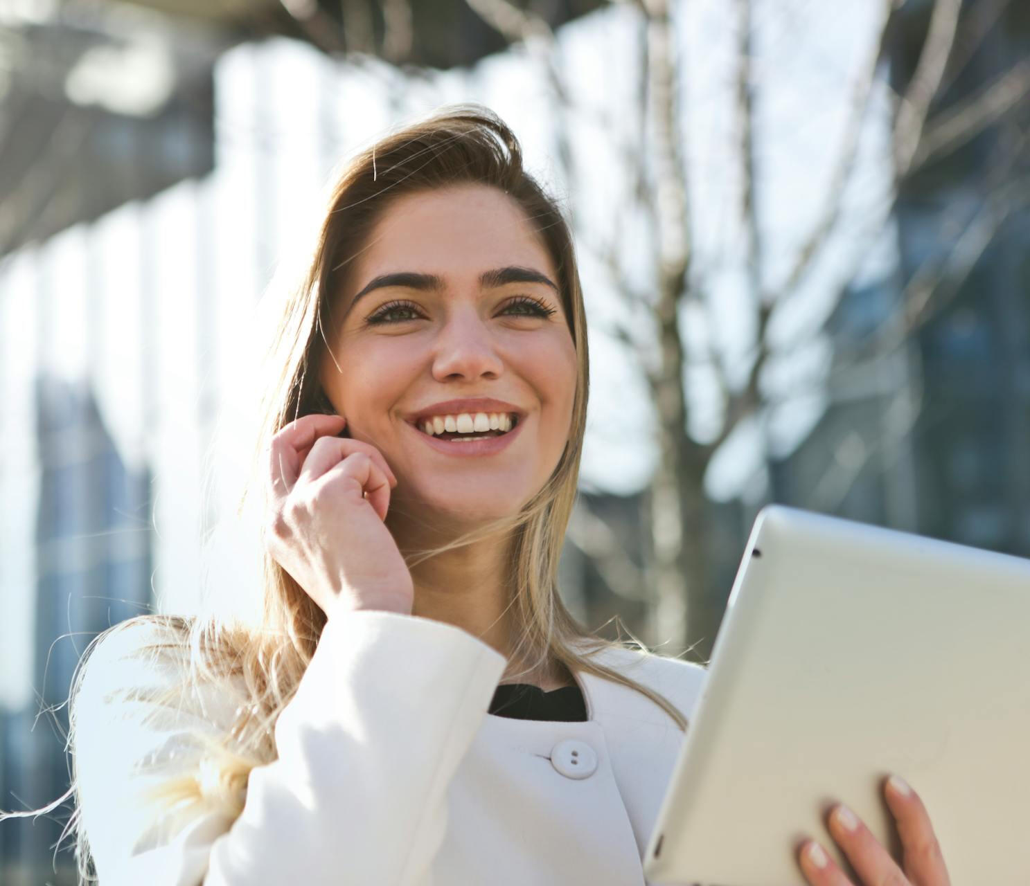 happy woman with computer in phone